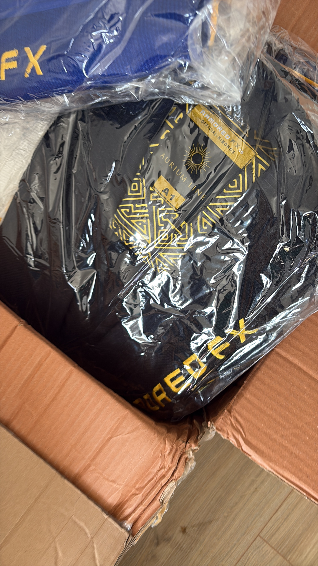 Packaged black Aurium Line gi inside shipping box.