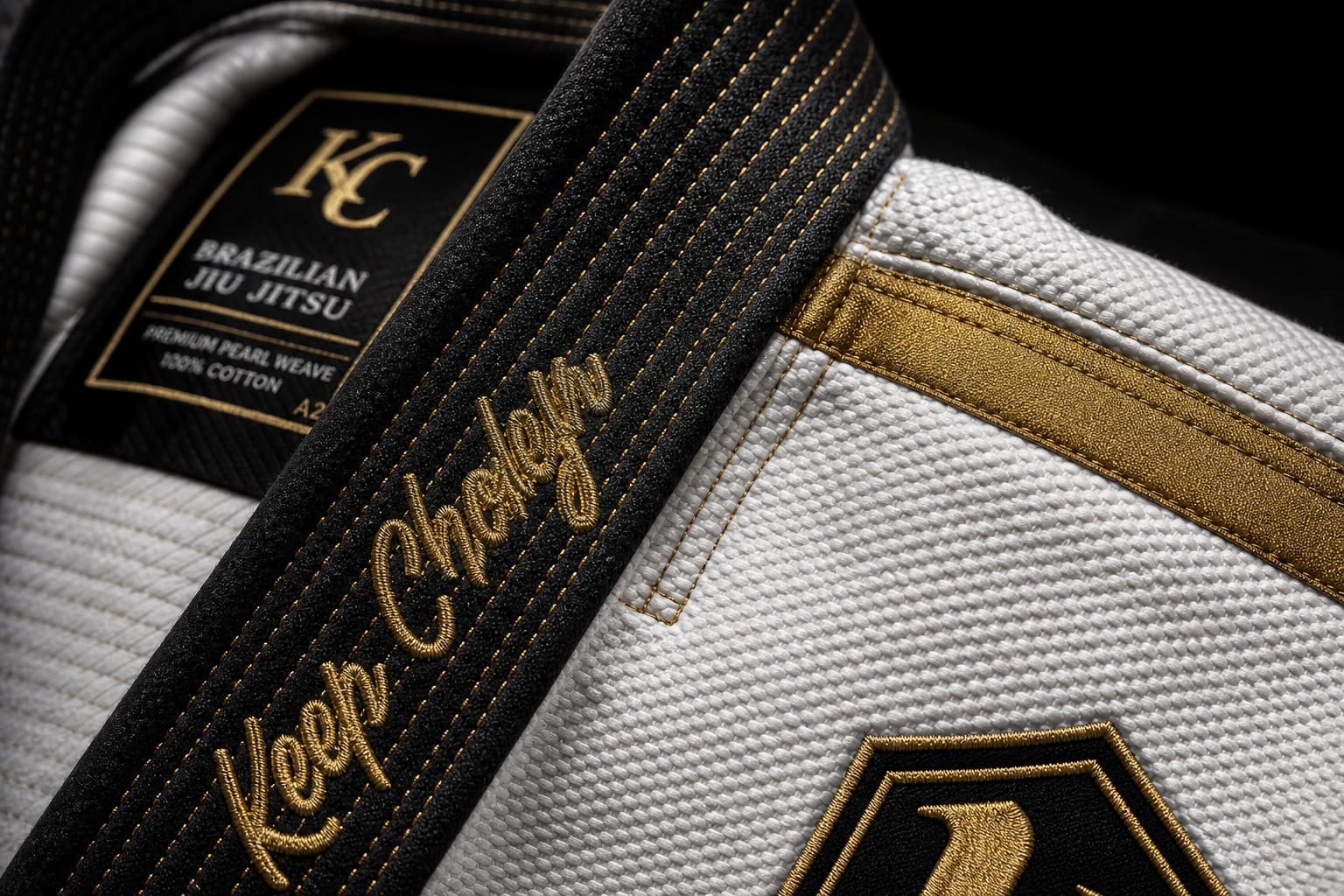 Close-up of premium 1,000-thread gold embroidery and reinforced stitching on the Aurium gi